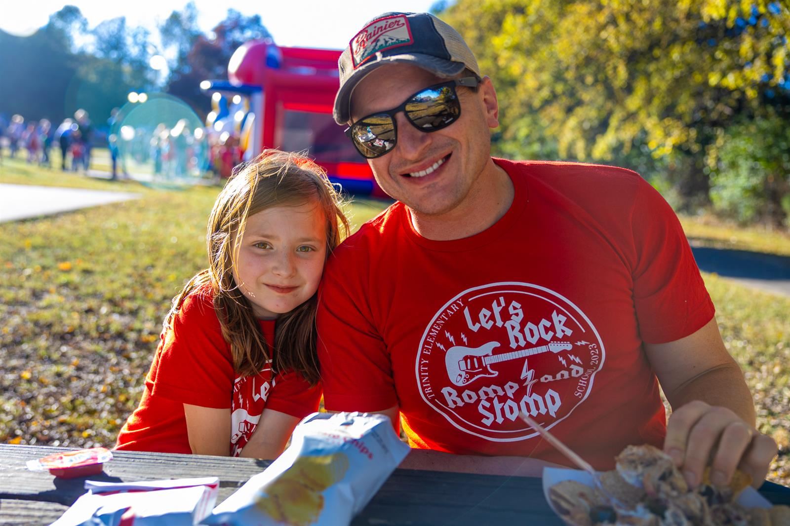 girl and her dad smiling